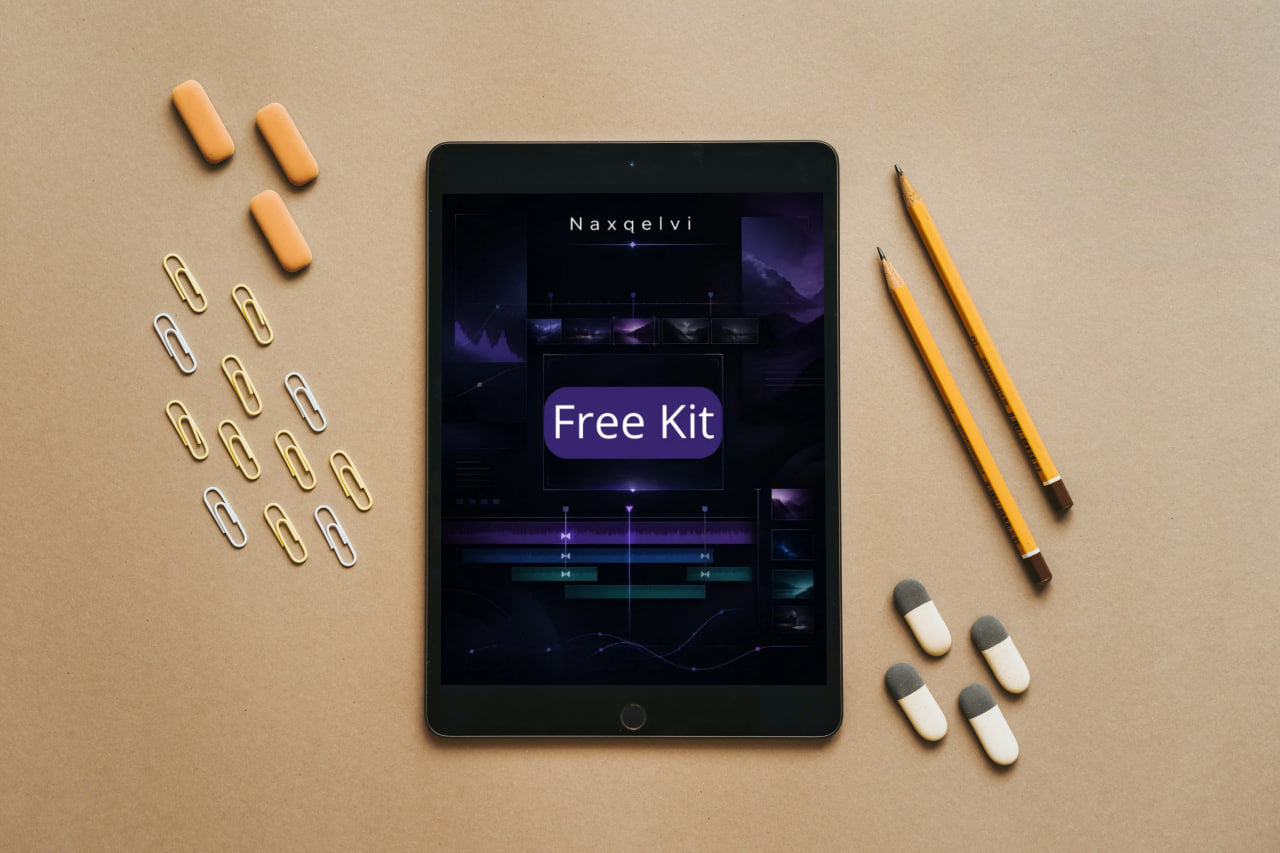 Tablet displaying 'Naxqelvi Free Kit' on a beige surface with pencils, paper clips, and capsules.